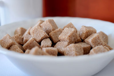 Close-up of a bowl of brown sugar cubes. 