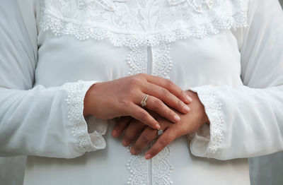 Midsection of couple holding hands