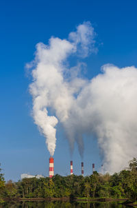 Smoke emitting from chimney against sky, coal power plant