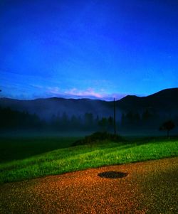 Scenic view of agricultural field against blue sky