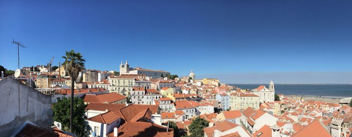 High angle view of town against blue sky