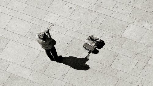 High angle view of musician playing trumpet on street