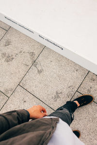 Low section of man standing on tiled floor