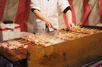 Midsection of chef preparing food in kitchen