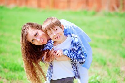 Portrait of happy friends on field