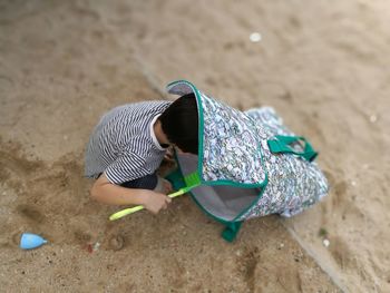 Midsection of boy on sand at beach