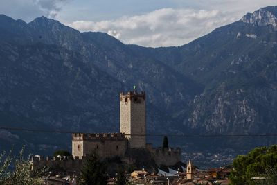 Buildings against sky with mountain in background