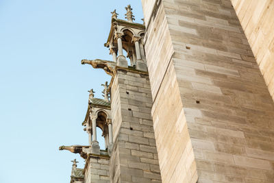 Low angle view of gargoyles against the sky in notre-dame cathedral