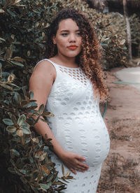 Pregnant woman standing by plants