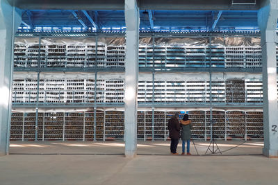 Rear view of man working at building