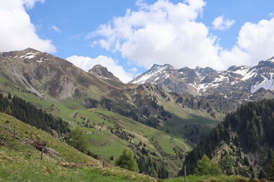 Scenic view of mountains against cloudy sky