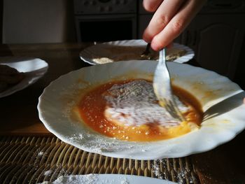 Close-up of hand holding ice cream