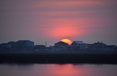 Scenic view of lake against romantic sky at sunset