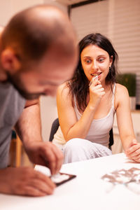 Side view of young woman working at home