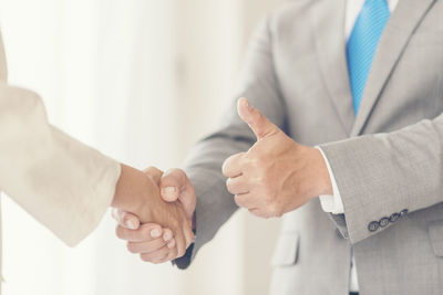 Close-up of business people shaking hands