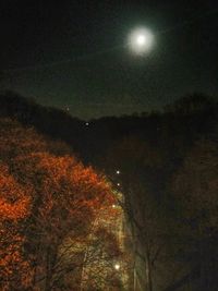 Low angle view of illuminated street light against sky