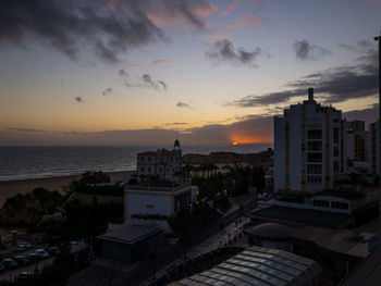 High angle view of buildings against cloudy sky