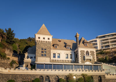 Low angle view of building against clear blue sky