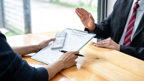 Midsection of business colleagues working in office