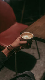 Hand holding coffee cup