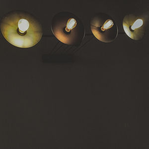 Low angle view of illuminated lights on ceiling