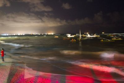 Illuminated city at waterfront