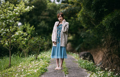 Full length of woman standing on rock