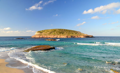 Scenic view of island and sea seen from cala comte