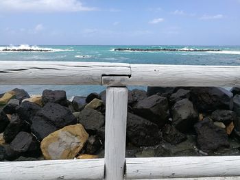 Close-up of rocks on beach against sky