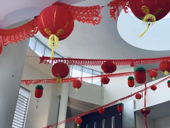 Low angle view of lanterns hanging by building