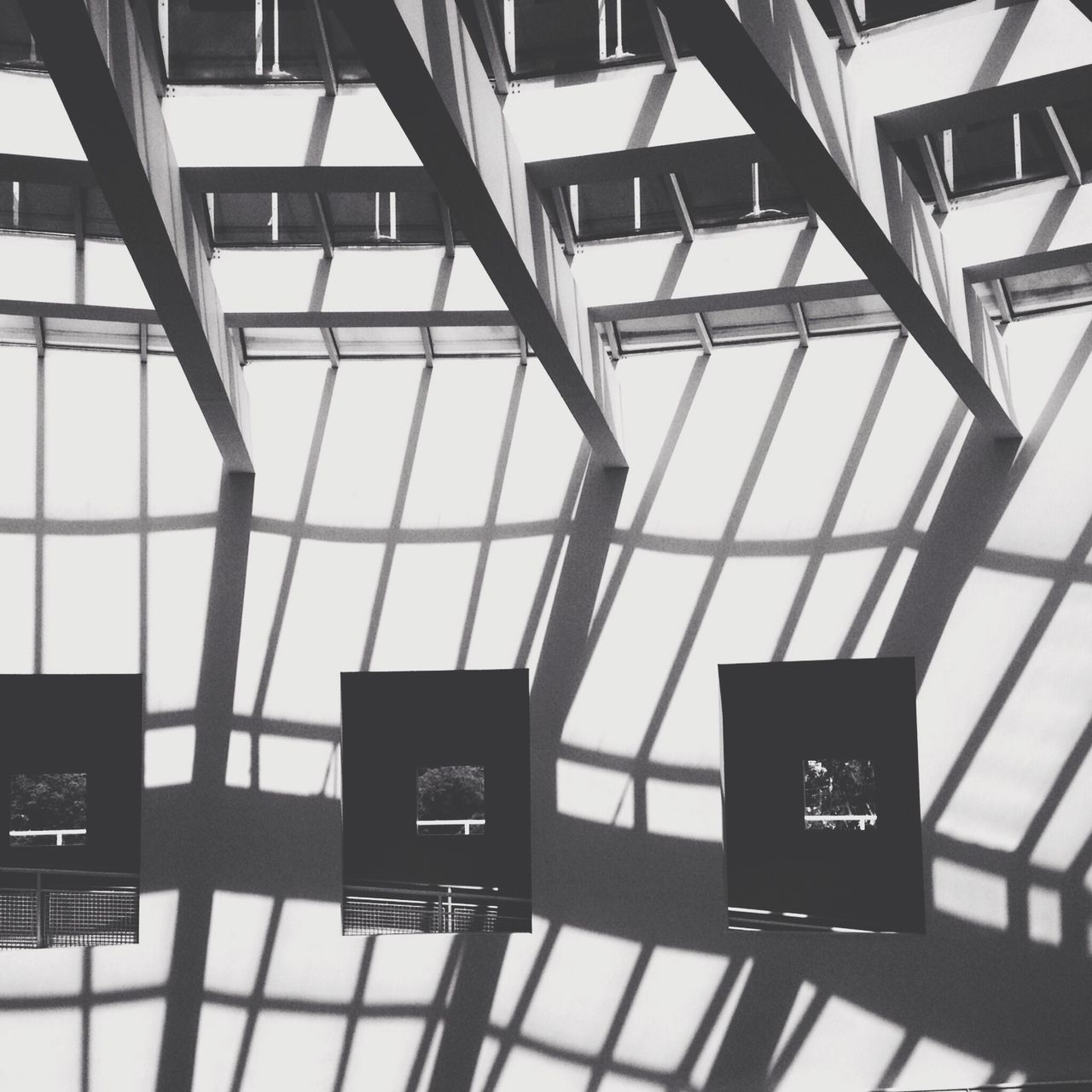 indoors, communication, built structure, architecture, technology, modern, low angle view, glass - material, text, window, connection, day, western script, no people, transparent, reflection, airport, chair, metal, ceiling