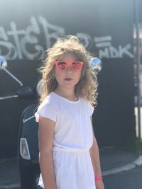 Girl wearing sunglasses standing outdoors