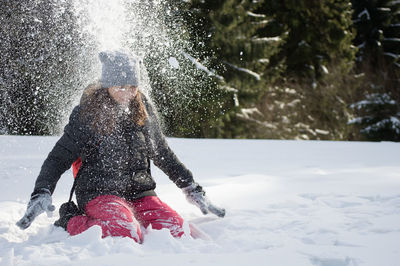 Girl playing in snow in snow