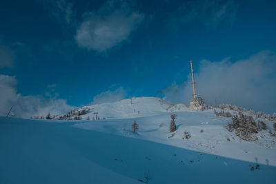 Snow covered landscape against sky