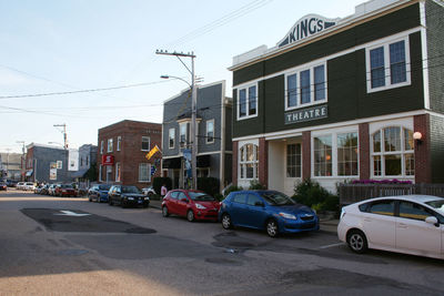 Cars on street by buildings in city