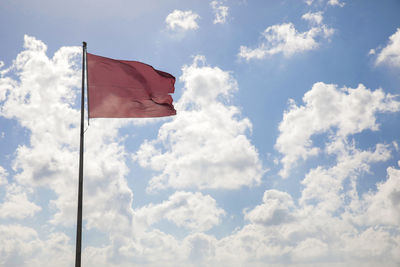 Low angle view of flag against sky