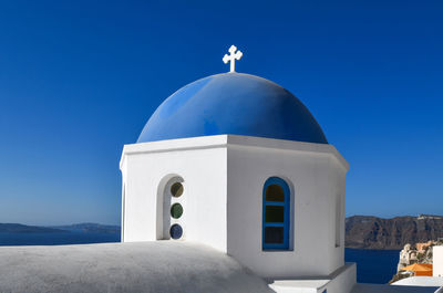 Low angle view of white building against clear blue sky