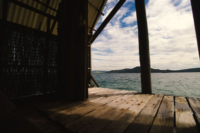 View of the sea as seen from inside a wooden bungalow