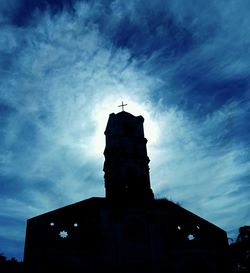 Low angle view of building against cloudy sky