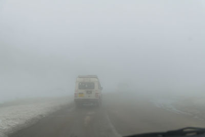 Car on road against sky during winter