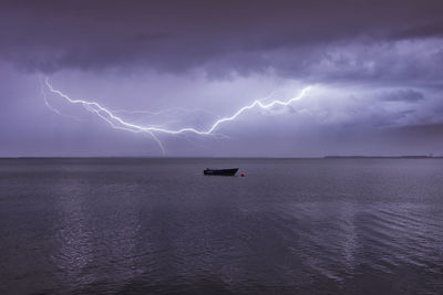 Lightning over sea against sky