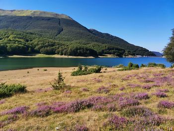 Scenic view of lake and mountains against sky