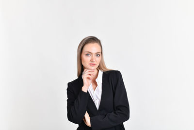 Portrait of businesswoman standing against white background