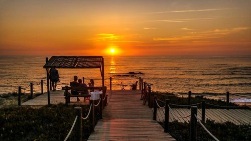 Scenic view of sea against sunset sky