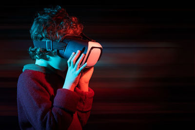 Kid wearing  360 vr goggles connected to metaverse