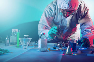 Man in protective workwear working in lab