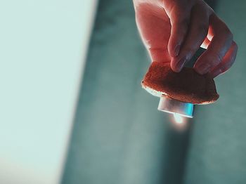 Close-up of hand holding candle