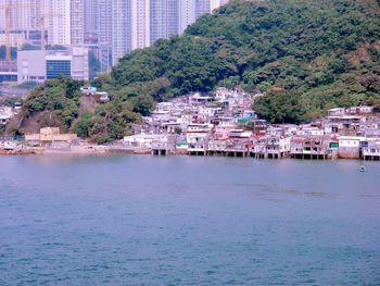 Scenic view of river by cityscape