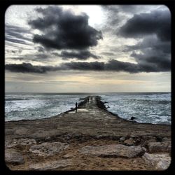 Scenic view of sea against cloudy sky