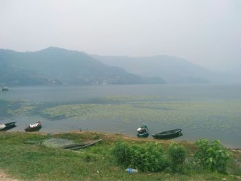 Scenic view of lake and mountains against sky